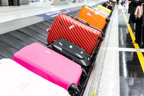 Suitcases on an airport baggage carousel.
