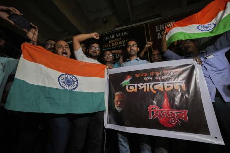 People holding Indian flags and a banner celebrating Operation Sindoor.