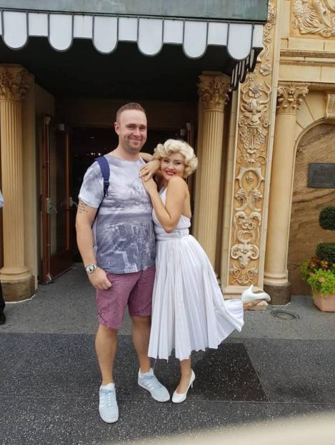 Couple posing in front of a building.