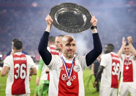 Erik ten Hag holding the Eredivisie trophy aloft.