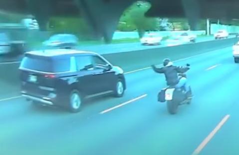 Dashcam footage of a minivan hitting a motorcyclist.