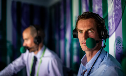 Two men wearing headsets commentating on a sporting event.