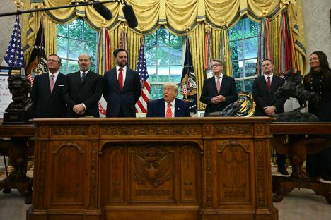 President Trump and several officials at a press conference in the Oval Office.
