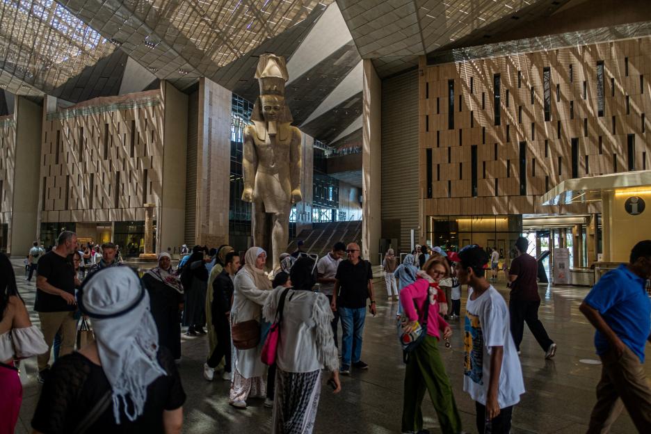 Visitors tour the Grand Egyptian Museum, featuring a colossal statue of Ramesses II.