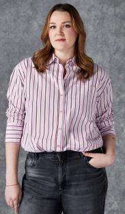 Frankie Dean in a striped shirt and jeans.