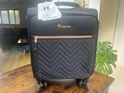 a black luggage bag that says it luggage on it