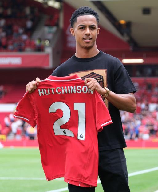 Omari Hutchinson holding his Nottingham Forest jersey.