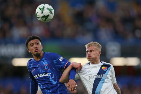 Jadon Sancho of Chelsea challenged for the ball by Viktor Bergh of Djurgarden during a soccer match.