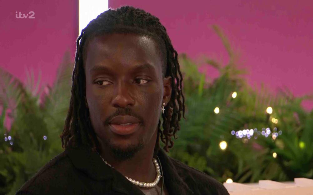 Dejon from Love Island looking pensive.
