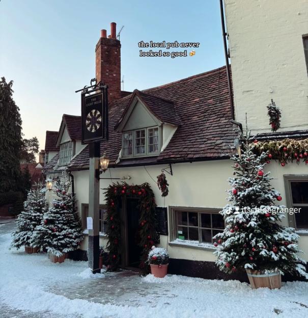 Snow-covered pub decorated for Christmas.