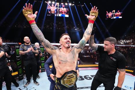 Tom Aspinall celebrates his UFC heavyweight championship victory.