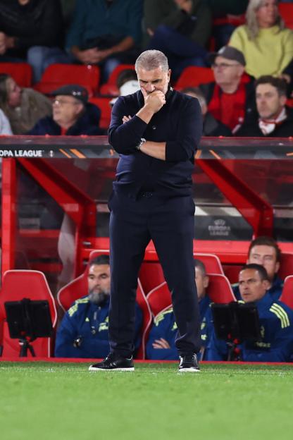 Ange Postecoglou, head coach of Nottingham Forest, deep in thought with his hand on his chin.
