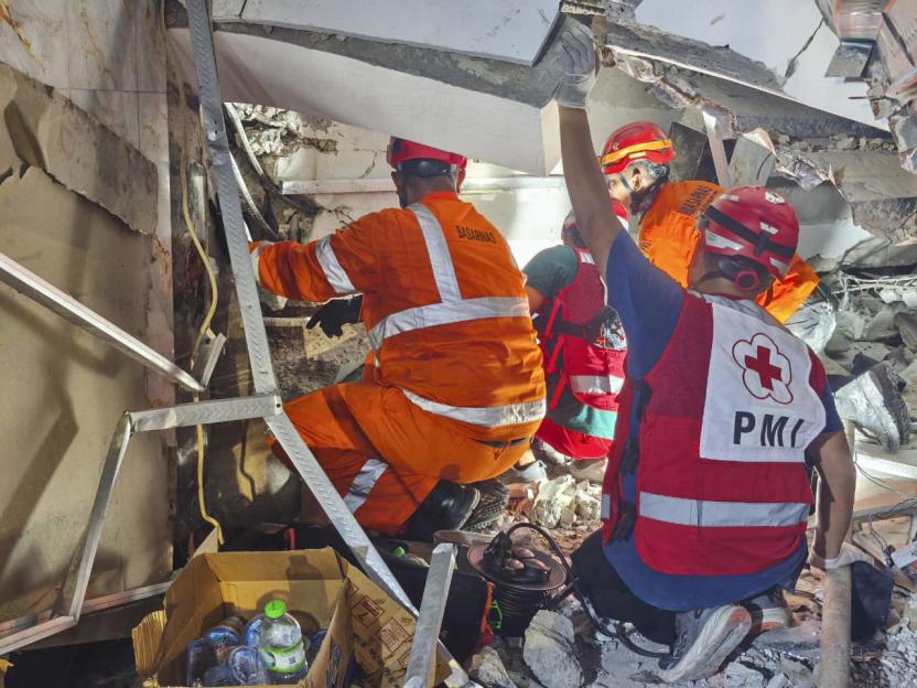Rescuers searching for victims in a collapsed prayer building at an Islamic boarding school in Sidoarjo, East Java, Indonesia.