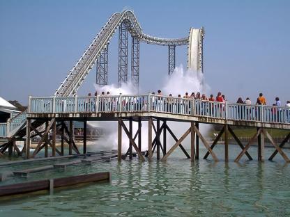 People watching a water ride at a closed theme park.
