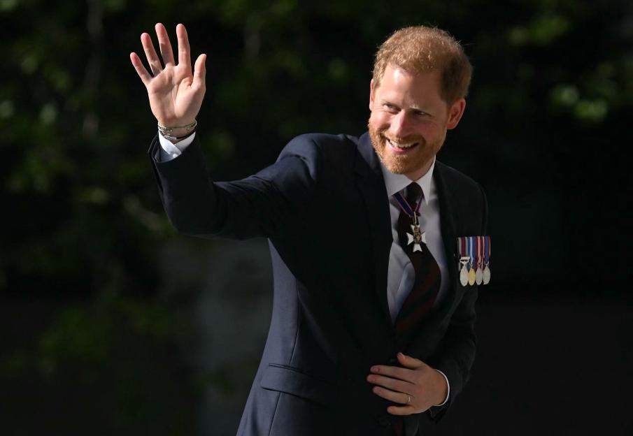 Prince Harry waving at an event.