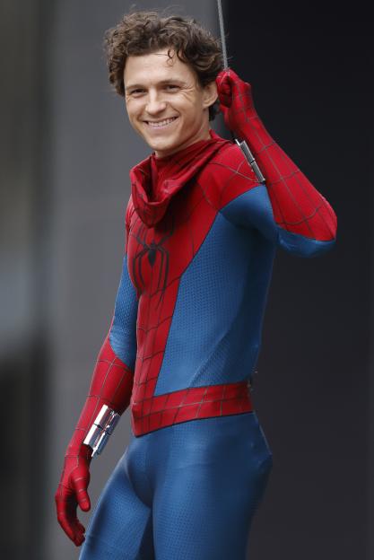 Tom Holland as Spider-Man, smiling while performing stunts.
