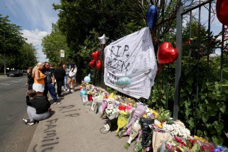 Floral tributes and messages at a memorial for two teenage boys.