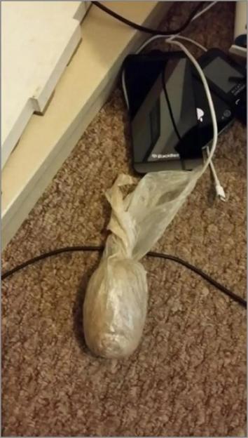 A bag of crack cocaine and heroin on a carpet.