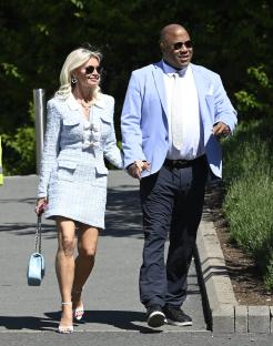 John Barnes and a woman walking hand-in-hand at Chester Races.
