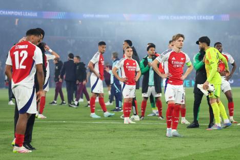 Arsenal players looking dejected after a Champions League semi-final match.