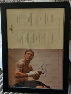 Framed photo of Tom Hardy with autograph.