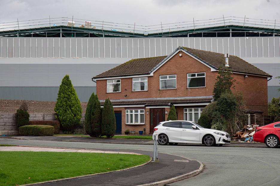 Aerial Images reveal the effects of living next to an enormous warehouse after cladding was installed blocking light and creating darkness. Residents in Tyldesley, Wigan, described being alarmed by the scale.