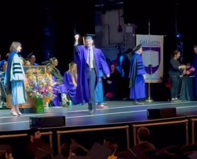 A graduate celebrates at his New York University graduation ceremony.