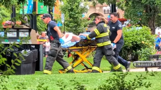 Firefighters carrying an injured person on a stretcher.