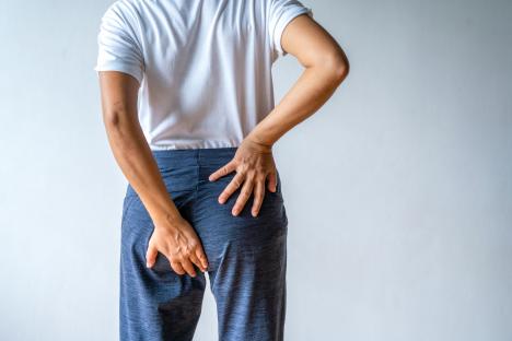 Woman holding her lower abdomen in pain.