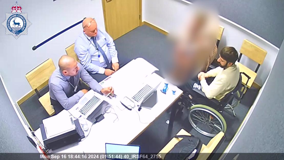 Screengrab of a police interview with a suspect in a wheelchair.
