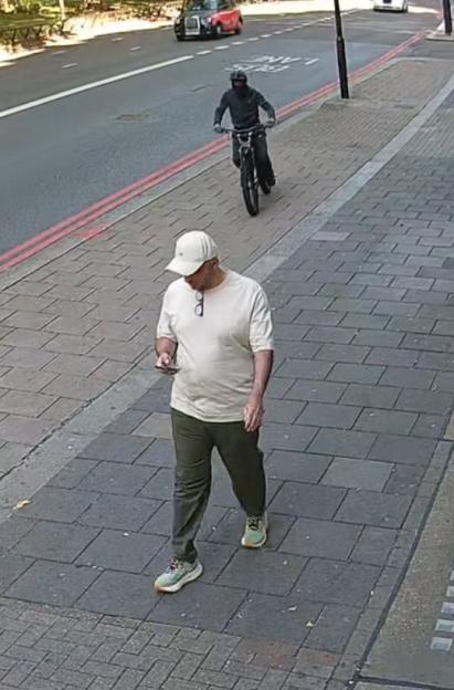 CCTV footage of a phone theft: A man has his phone snatched by a thief on an e-bike.