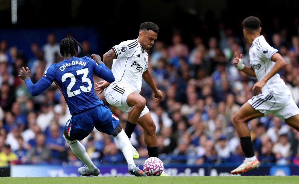 Rodrigo Muniz of Fulham and Trevoh Chalobah of Chelsea battling for the ball during a Premier League match.