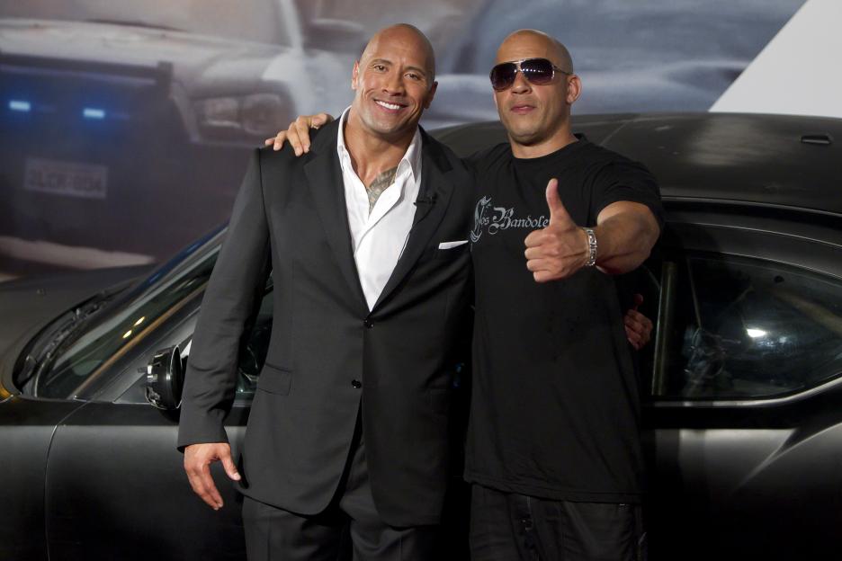 Dwayne Johnson and Vin Diesel posing at the premiere of "Fast and Furious 5."