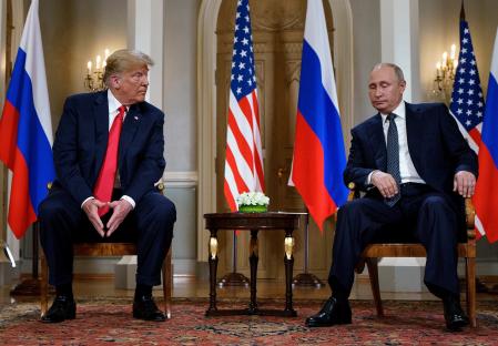 Presidents Trump and Putin seated together during a meeting.