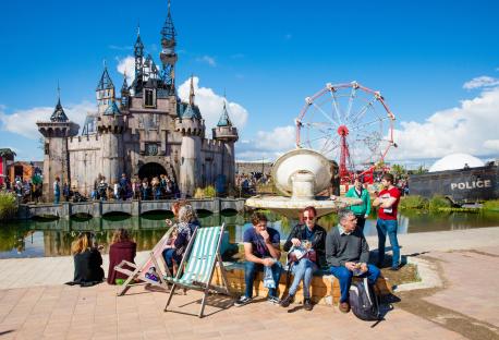People enjoying Dismaland, a temporary art installation by Banksy.