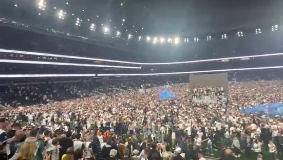 Tottenham Hotspur fans celebrating a Europa League victory at Tottenham Hotspur Stadium.