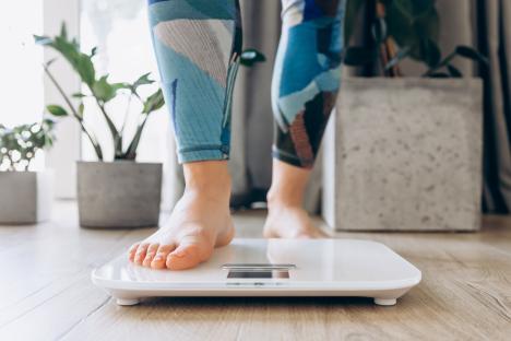 Woman's feet on a bathroom scale.