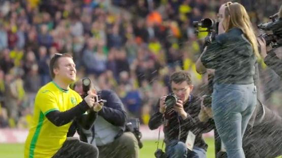 Moment Norwich fan proposes to shocked girlfriend on pitch ruined as fans start singing brutal chant at happy couple