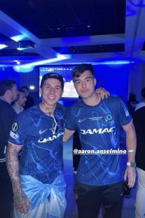 Two men in Chelsea jerseys posing for a photo.