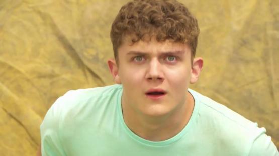 Shocked young man in a light green shirt.