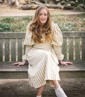Lucy Upton, a paediatric dietitian and author, sitting on a park bench.