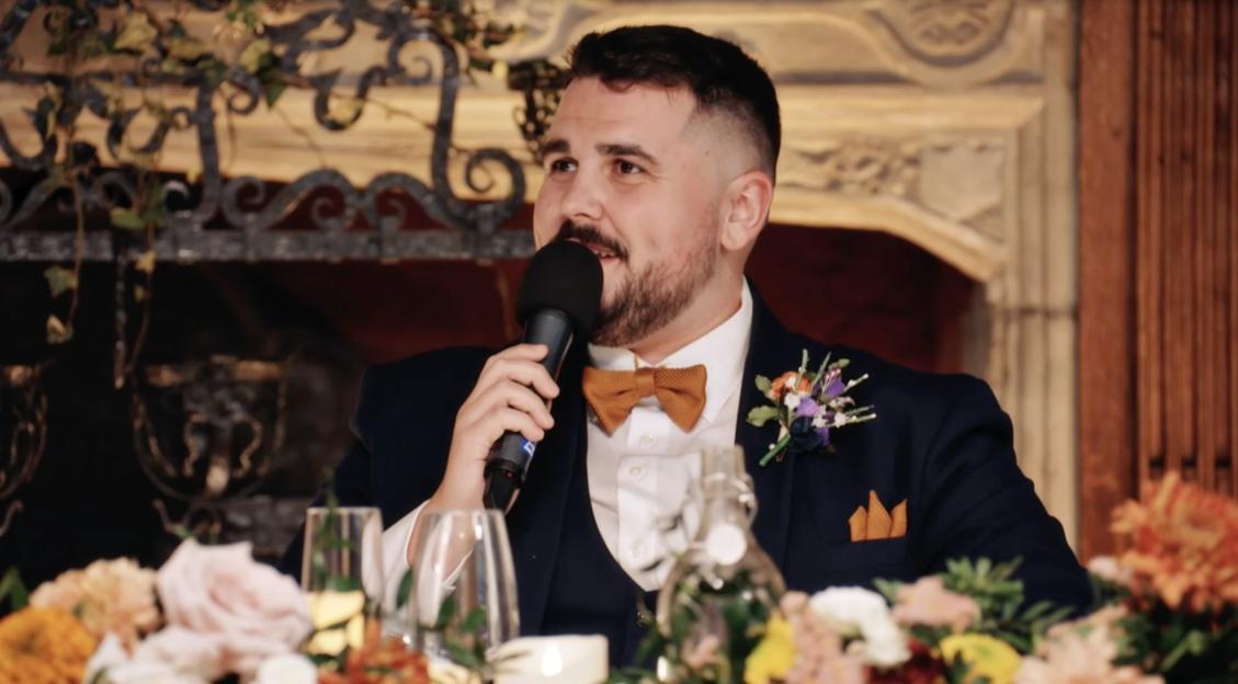 Groom speaking at wedding reception.