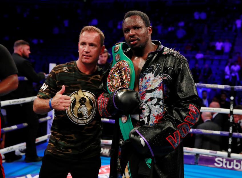Dillian Whyte celebrates a boxing victory with his trainer.