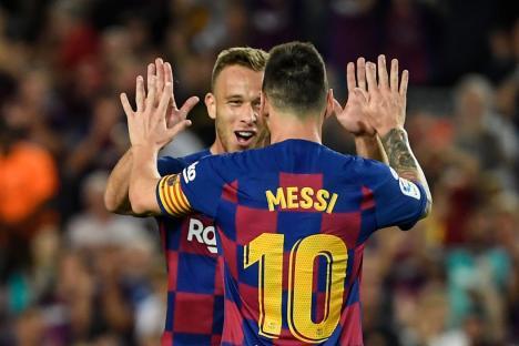 Barcelona's Brazilian midfielder Arthur is congratulated by teammate Barcelona's Argentine forward Lionel Messi after scoring the second goal during the Spanish league football match between FC Barcelona and Villarreal CF at the Camp Nou stadium in Barcelona, on September 24, 2019. (Photo by LLUIS GENE / AFP) (Photo credit should read LLUIS GENE/AFP via Getty Images)