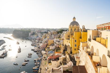 High-angle view of a colorful Italian coastal town with a harbor full of boats.