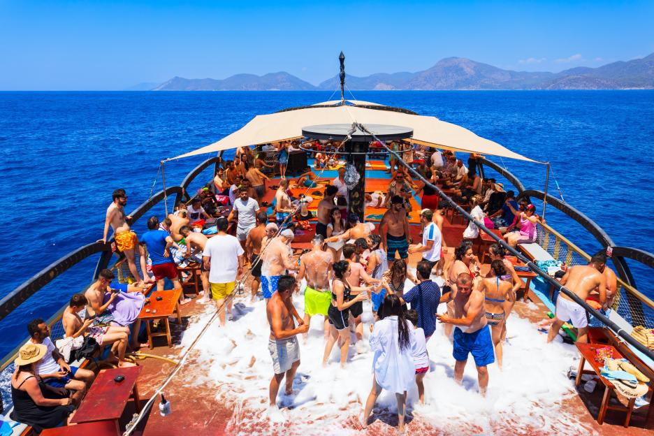 People dancing at a foam party on a boat on the Aegean Sea near Oludeniz beach in Turkey.