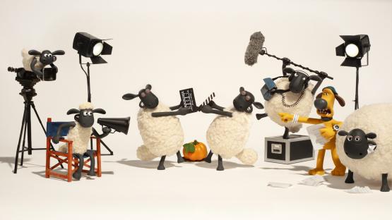 Illustration of Shaun the Sheep characters filming a movie.