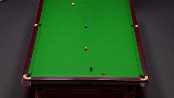 Snooker table with several balls in play.