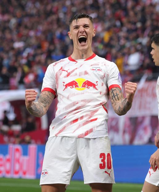 Benjamin Sesko of RB Leipzig celebrates scoring a goal.
