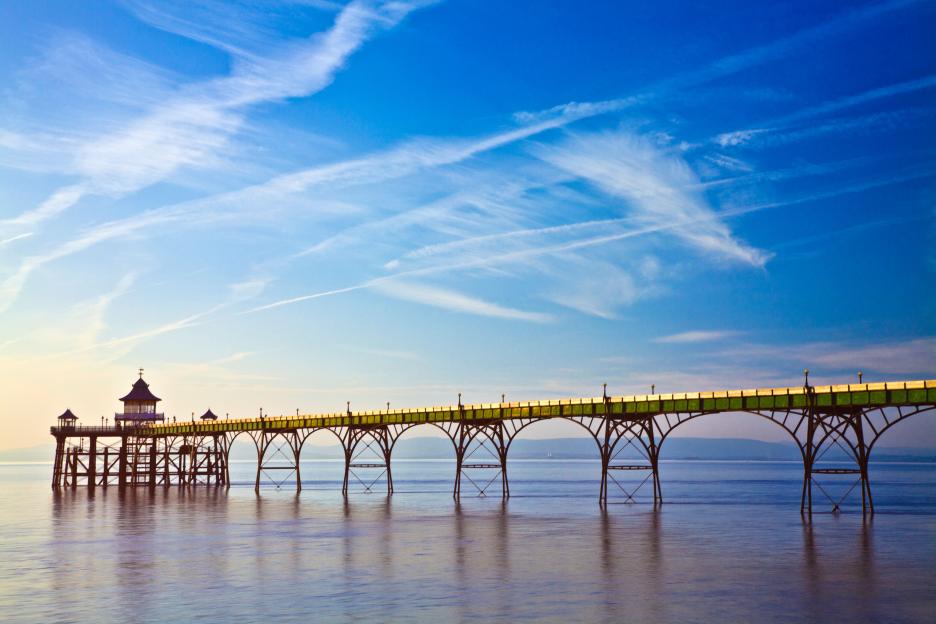 Clevedon Pier in Somerset, England, with evening light falling on it.